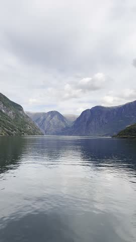 Majestic Norwegian fjords captured from a boat, from the road, and from above, under sun and rain.