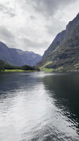 Majestic Norwegian fjords captured from a boat, from the road, and from above, under sun and rain.