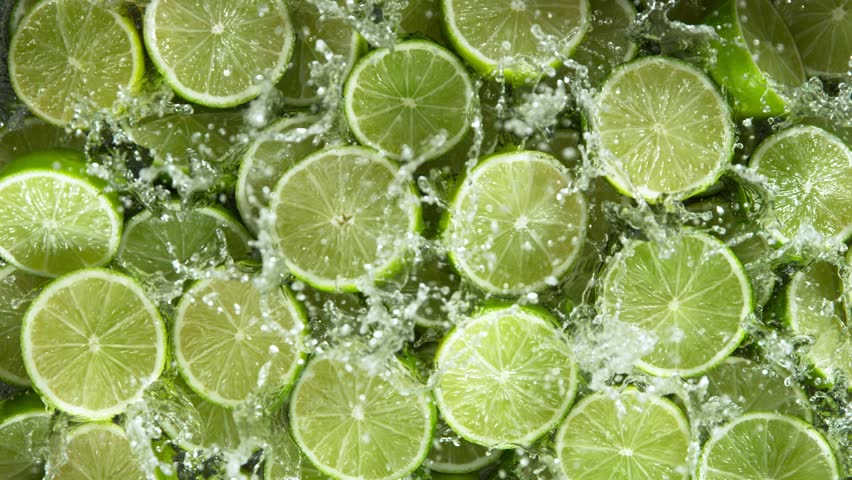 Super Slow Motion Shot of Fresh Limes Falling into Water at 1000 fps