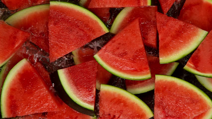 Super Slow Motion Shot of Fresh Pieces of Watermelons Falling into Water at 1000 fps