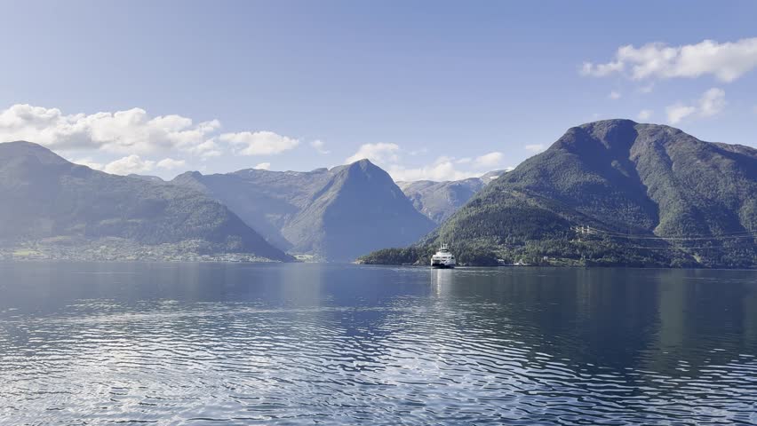 Majestic Norwegian fjords captured from a boat, from the road, and from above, under sun and rain.