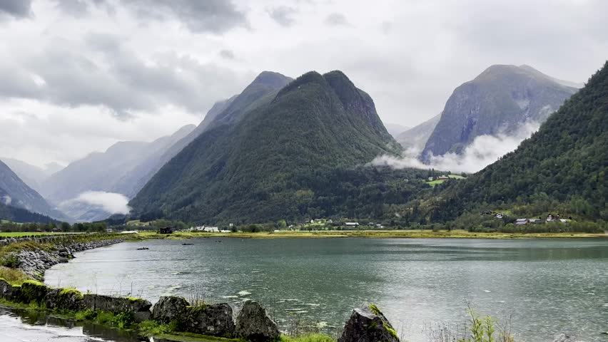 Majestic Norwegian fjords captured from a boat, from the road, and from above, under sun and rain.