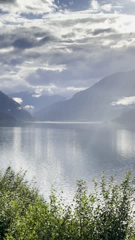 Majestic Norwegian fjords captured from a boat, from the road, and from above, under sun and rain.