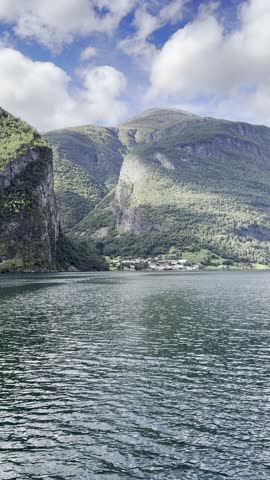 Majestic Norwegian fjords captured from a boat, from the road, and from above, under sun and rain.