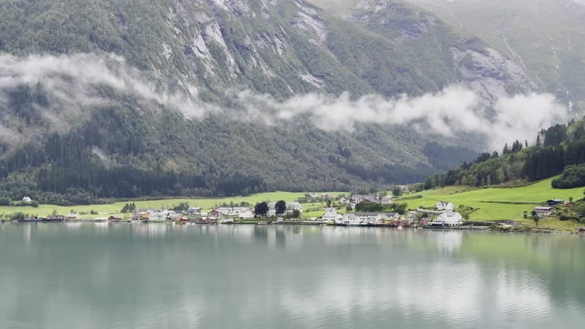 Majestic Norwegian fjords captured from a boat, from the road, and from above, under sun and rain.