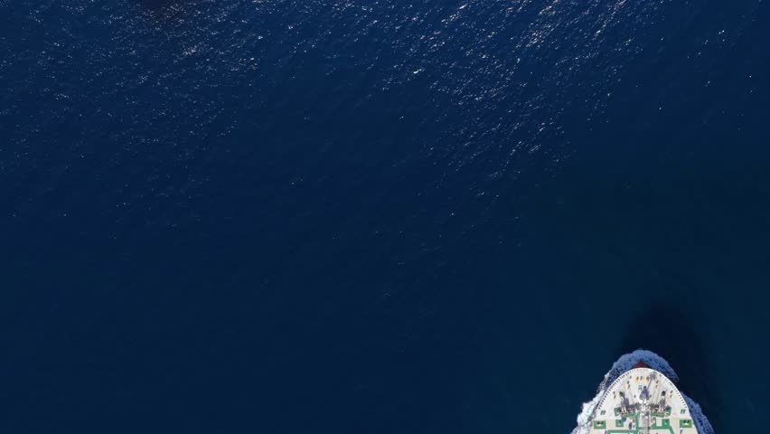 Aerial overhead view of a cargo container ship and a crude oil tanker crossing the ocean as a concept for industrial transport