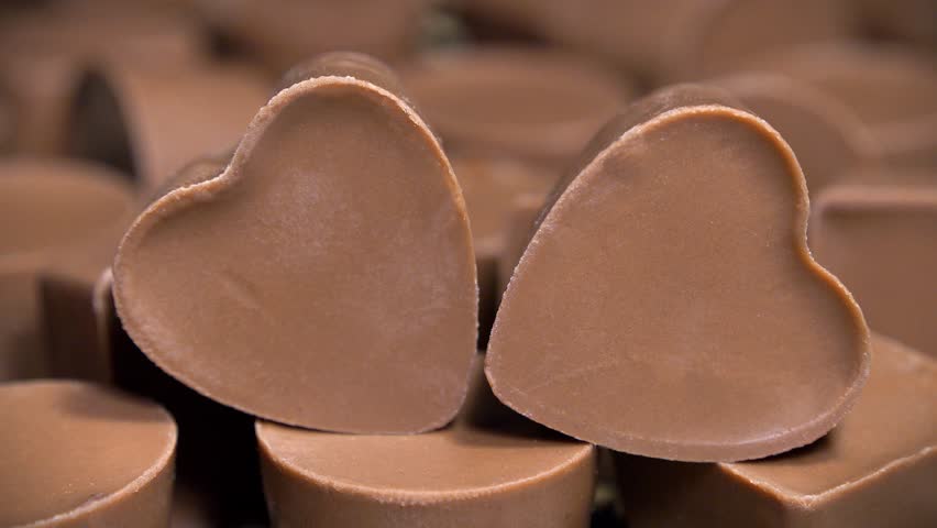 Heart-shaped chocolate candy. Delicious gifts for Valentines Day. Sweetness, pleasure and love
