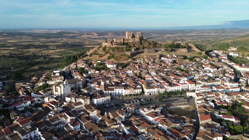 Aerial view approaching Luna Castle over the town of Alburquerque in Badajoz, Spain.