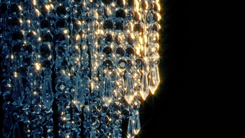Moving Past Chandelier In Glowing Light