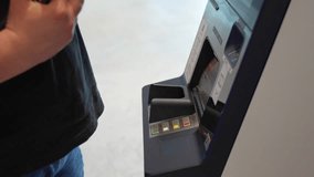 Person wearing leather watch depositing cash money into ATM machine at modern bank terminal with digital interface. Concept of banking services, financial deposits and automated transaction technology - Powered by Shutterstock - Get 15% off with code: PIKWIZARD15