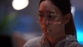 A female programmer concentrates on her computer screen, with code projected onto her face and glasses. This image represents a deep focus on software development and data. - Powered by Shutterstock - Get 15% off with code: PIKWIZARD15