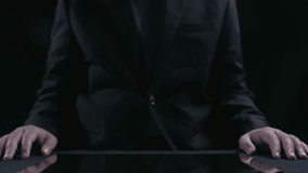 A businessman presents a holographic display featuring graphs and icons related to cost reduction strategies, showcasing financial analytics in a dark and professional setting. Qubit - Powered by Shutterstock - Get 15% off with code: PIKWIZARD15