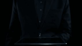 A businessman interacts with a digital tablet, showcasing a target symbol with data visuals. This image represents modern strategies for achieving business goals and success. Qubit - Powered by Shutterstock - Get 15% off with code: PIKWIZARD15