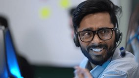 A diverse team of customer support agents works in a modern call center. Smiling operators assist clients over the phone, providing helpful and professional technical support. - Powered by Shutterstock - Get 15% off with code: PIKWIZARD15