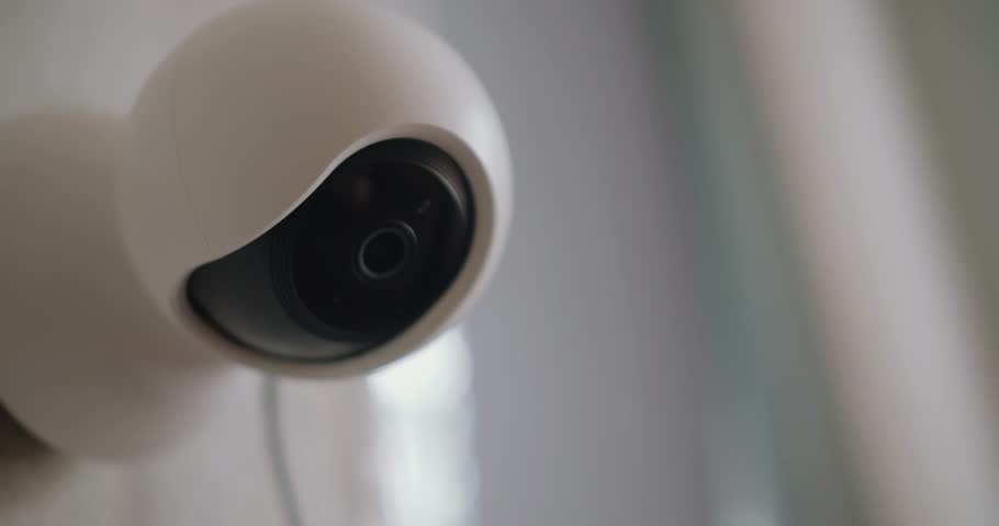 Closeup of video baby monitor with camera for watching baby at nursery room. Safety and security concept. CCTV, secure, monitoring concept. CCTV cameras are located inside the house.