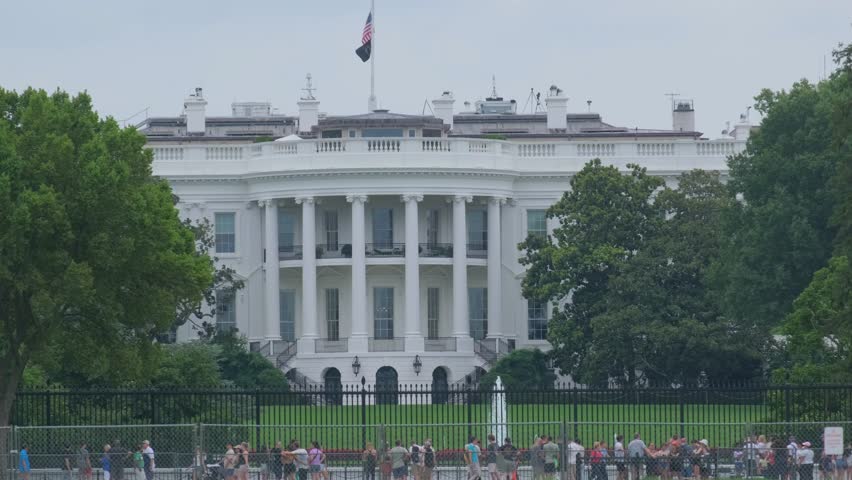 The US White House with lush trees and visitors enjoying the beautiful view