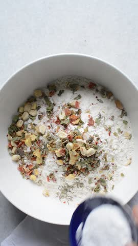 overhead view of savory biscotti ingredients in a bowl, top view of savory cookie ingredients in a mixing bowl