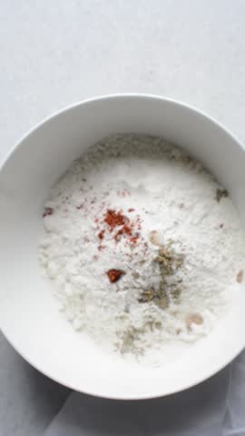 overhead view of savory biscotti ingredients in a bowl, top view of savory cookie ingredients in a mixing bowl