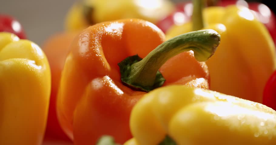 A vibrant close-up image of fresh, colorful bell peppers in red, yellow, and orange, showcasing their natural beauty and freshness. Fresh Colorful Bell Peppers Close-Up