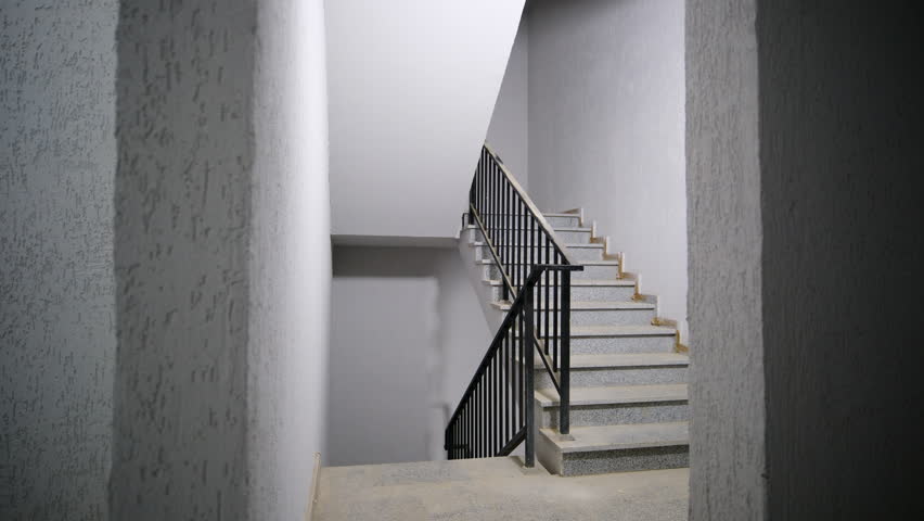 Slider shot of Interior view of a spacious, unfinished room featuring large glass windows that let in natural light, providing a view of greenery, giving an impression of future potential and openness