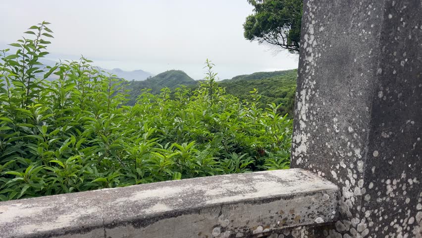 Breathtaking Scenic Overlook Showcasing Lush Green Hills and Imposing Mountain Range