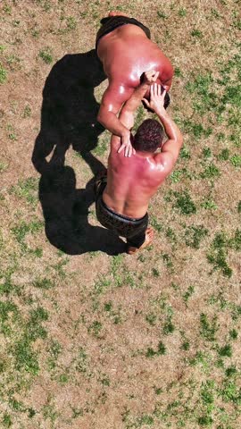 Wrestlers doing oil wrestling - 4K vertical video of wrestlers doing traditional Turkish oil wrestling