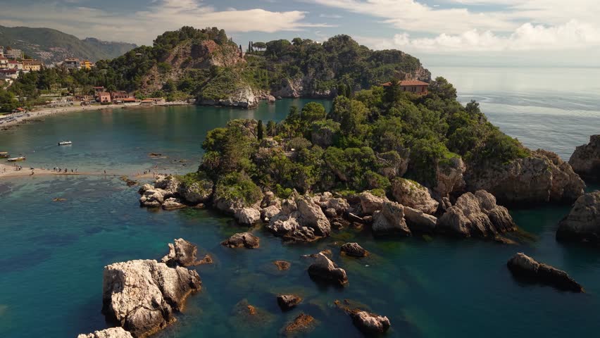 Aerial view rising above the stunning Isola Bella island lush islet near Taormina, Sicily