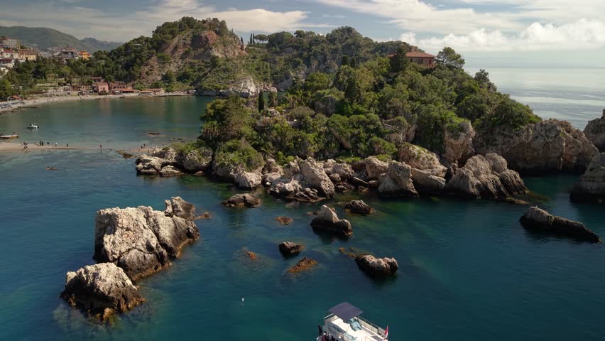 Aerial view rising over the stunning Isola Bella island islet near Taormina, Sicily