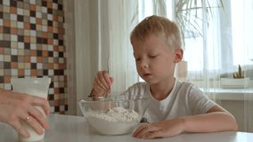 In a bright kitchen, a mother and her young son joyfully mix ingredients to prepare fluffy pancakes. Their laughter fills the room as they share quality time making breakfast. - Powered by Shutterstock - Get 15% off with code: PIKWIZARD15