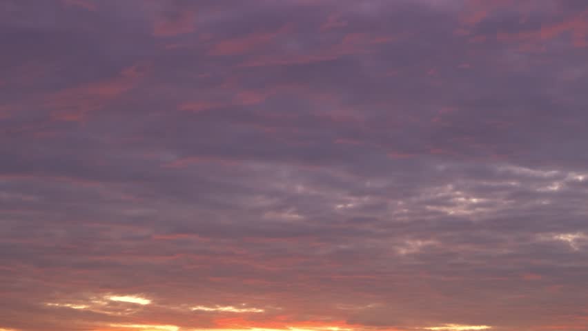 A sunrise sky timelapse, painted in fiery orange and deep purple, conveys the concept of renewal, symbolizing new beginnings, resilience, hope, and the transformative beauty of nature’s daily rhythm.
