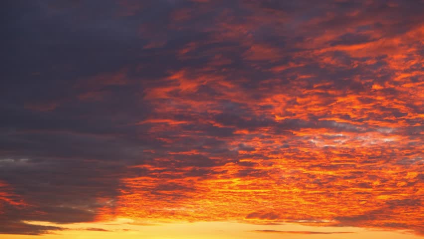 A sunrise sky timelapse, painted in fiery orange and deep purple, conveys the concept of renewal, symbolizing new beginnings, resilience, hope, and the transformative beauty of nature’s daily rhythm.
