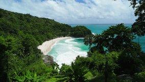 Aerial approach ascends with pan reveal of turquoise Freedom Beach cove, Phuket - Powered by Shutterstock - Get 15% off with code: PIKWIZARD15