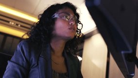 Focused business professional with glasses analyzes computer monitor in modern office. Scene shows technology use, data analysis, concentration, thinking, and deep focus in a work environment. - Powered by Shutterstock - Get 15% off with code: PIKWIZARD15