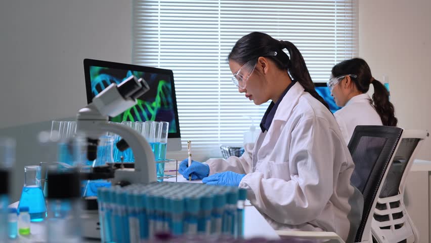 Female scientist working with test tubes and liquids in modern laboratory, conducting experiments and research - Powered by Shutterstock - Get 15% off with code: PIKWIZARD15