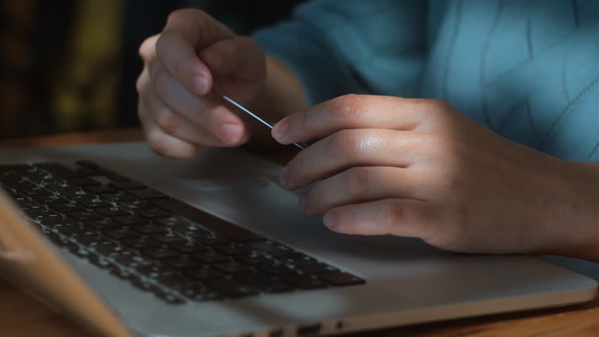Digital transactions and online payments. A woman transfers money online using bank credit card and laptop.