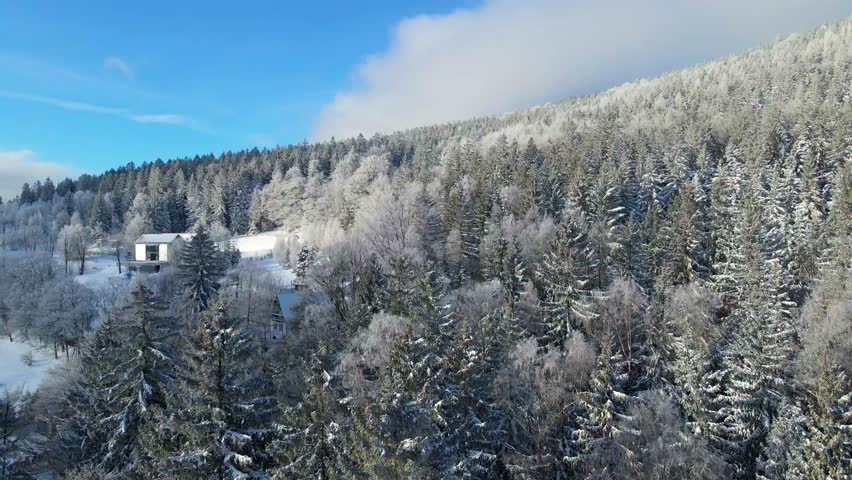 winter landscape mountains forest drone flyby blue sky