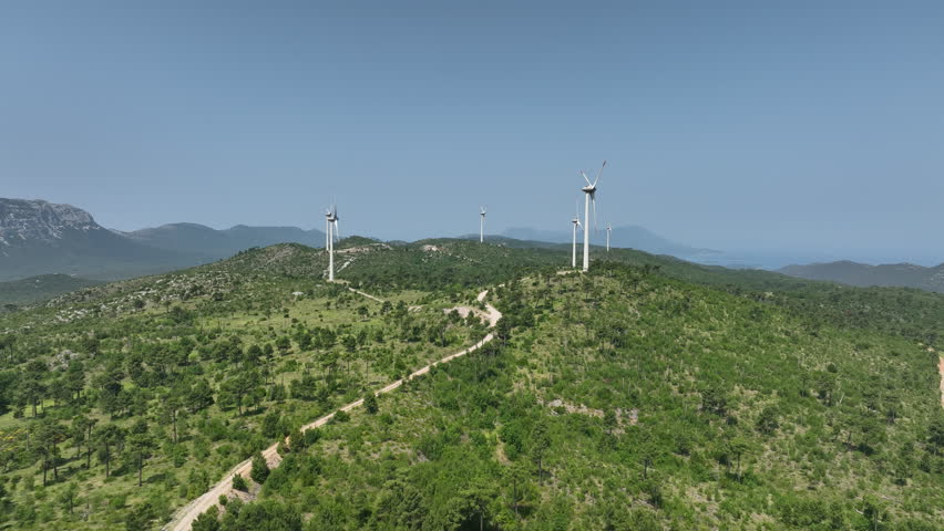 Wind Turbines Dotting Lush Croatian Hills with Distant Coastal View
