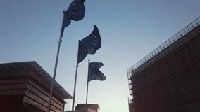 EU flag waving in front of Brussels headquarters with animated fingerprint graphics representing security - Powered by Shutterstock - Get 15% off with code: PIKWIZARD15