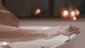 Woman rubs hand with foamy loofah in bathroom close up. Lady washes body skin with mesh sponge in shower cabin. Massage during hygienic procedure. woman taking bath while rubbing leg with soap. female - Powered by Shutterstock - Get 15% off with code: PIKWIZARD15