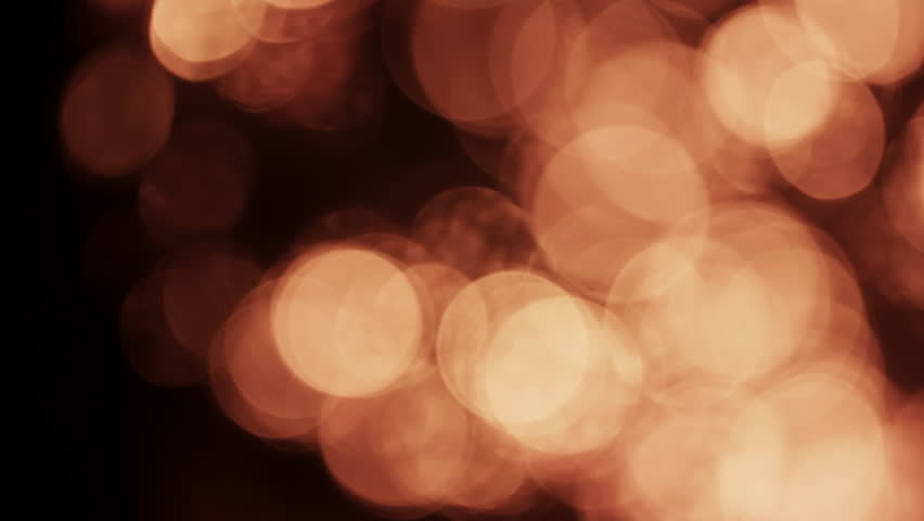 Sparkling bokeh circles shimmer softly, created by glowing fire embers for a warm, magical effect