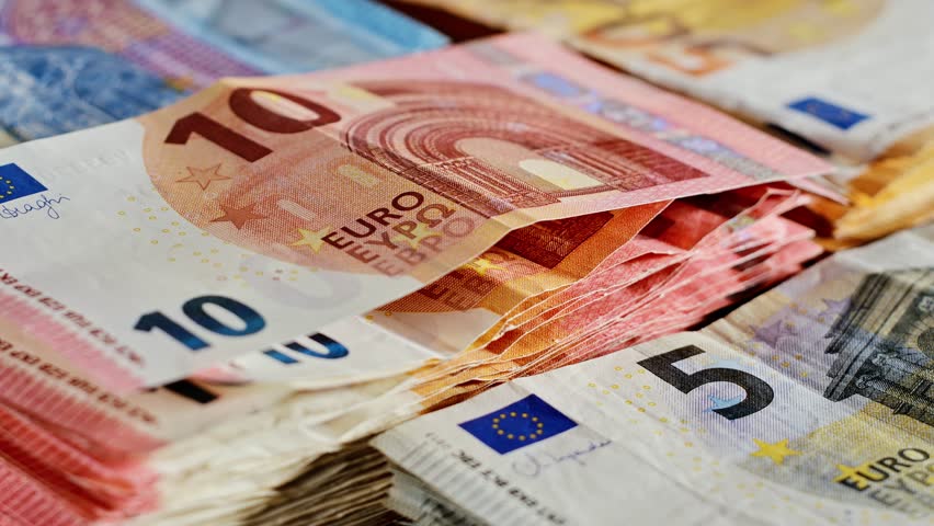 Euro banknote stacks rotating under light, symbolizing wealth in motion