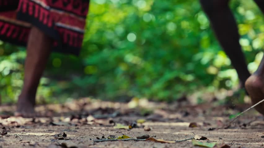 Vedda tribesman of Sri Lanka dancing a ritual dance before hunting, traditional lifestyle, and connection to nature. Tribal portrait in native Habitat 120 fps slow motion.