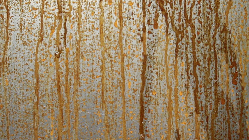 Close-up of water droplets flowing down a Corten steel surface, enhancing the natural rust patina. - Powered by Shutterstock - Get 15% off with code: PIKWIZARD15