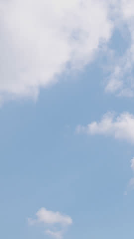 A tranquil time-lapse view from an airplane window shows soft white clouds drifting over a deep azure sky, evoking peace, freedom, aerial travel and open horizons in high definition.
