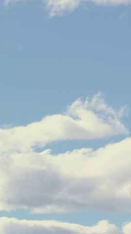 A tranquil time-lapse view from an airplane window shows soft white clouds drifting over a deep azure sky, evoking peace, freedom, aerial travel and open horizons in high definition.
