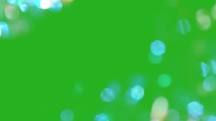 An illustration of soft, blurred bokeh light orbs floating against a vibrant green screen background, perfect for chroma key compositing