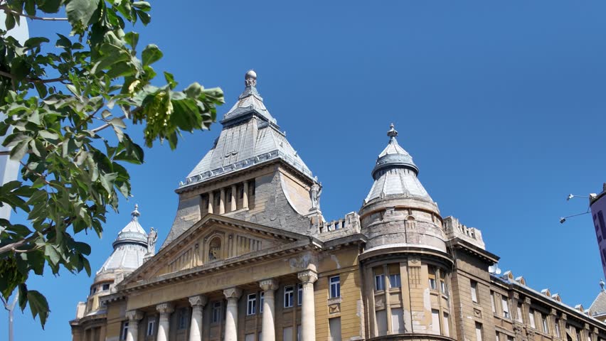 Pan-down of Anker Palota in Budapest, highlighting its elegant neoclassical facade, intricate details, and architectural design