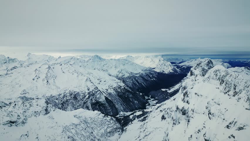 Snowy rocky mountains at winter in Switzerland, Engelberg, Titlis. Panorama of Swiss Alps with mountain ranges covered in snow on background. Picturesque nature winter landscape