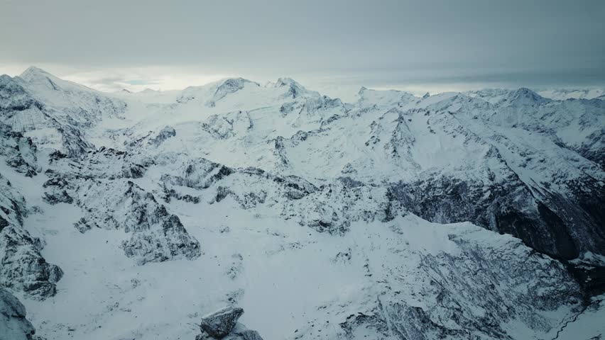 Panoramic view of snowy rocky mountains in Switzerland. Mountain summits covered in fresh snow, Engelberg, Swiss Alps. Picturesque panorama of winter mountains, Titlis