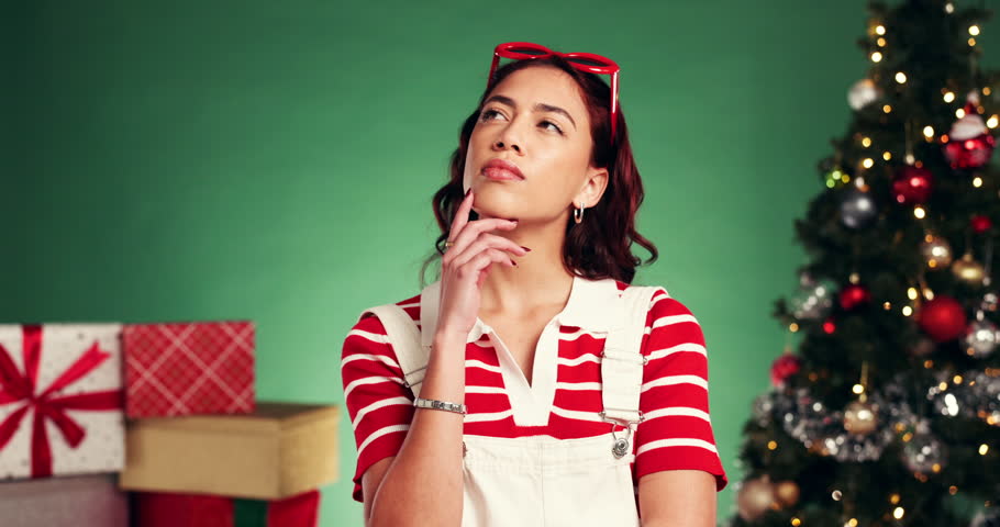 Thinking, woman and confused on Christmas in studio of gift ideas, celebrate holiday and tradition. Mockup space, person and dont know for questions, xmas season and doubt present on green background